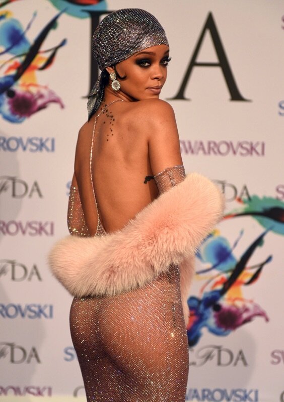 Rihannna is sporting an erotic dress that clings to her hot curves & is just sheer enough to show she's is bare naked underneath. picture
