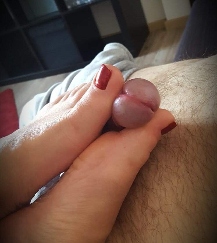 Red nails footjob picture