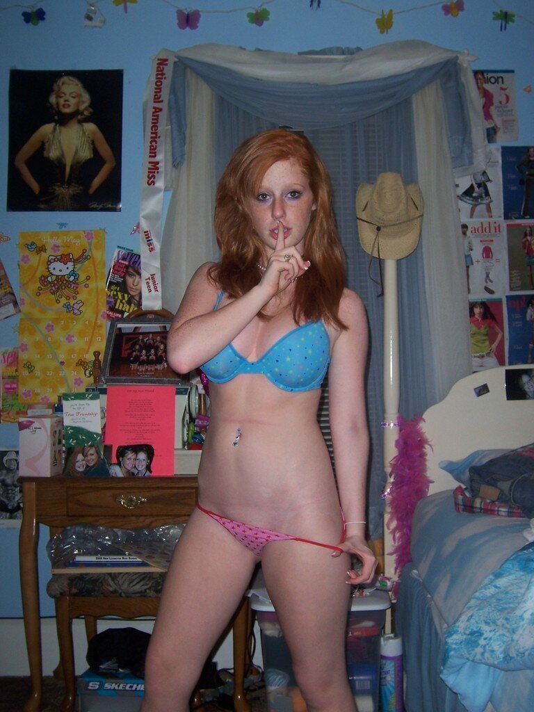 Young redhead pulling off her panties picture