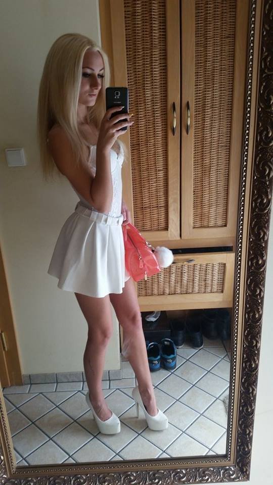Blonde bimbo in cute white dress and high heels picture