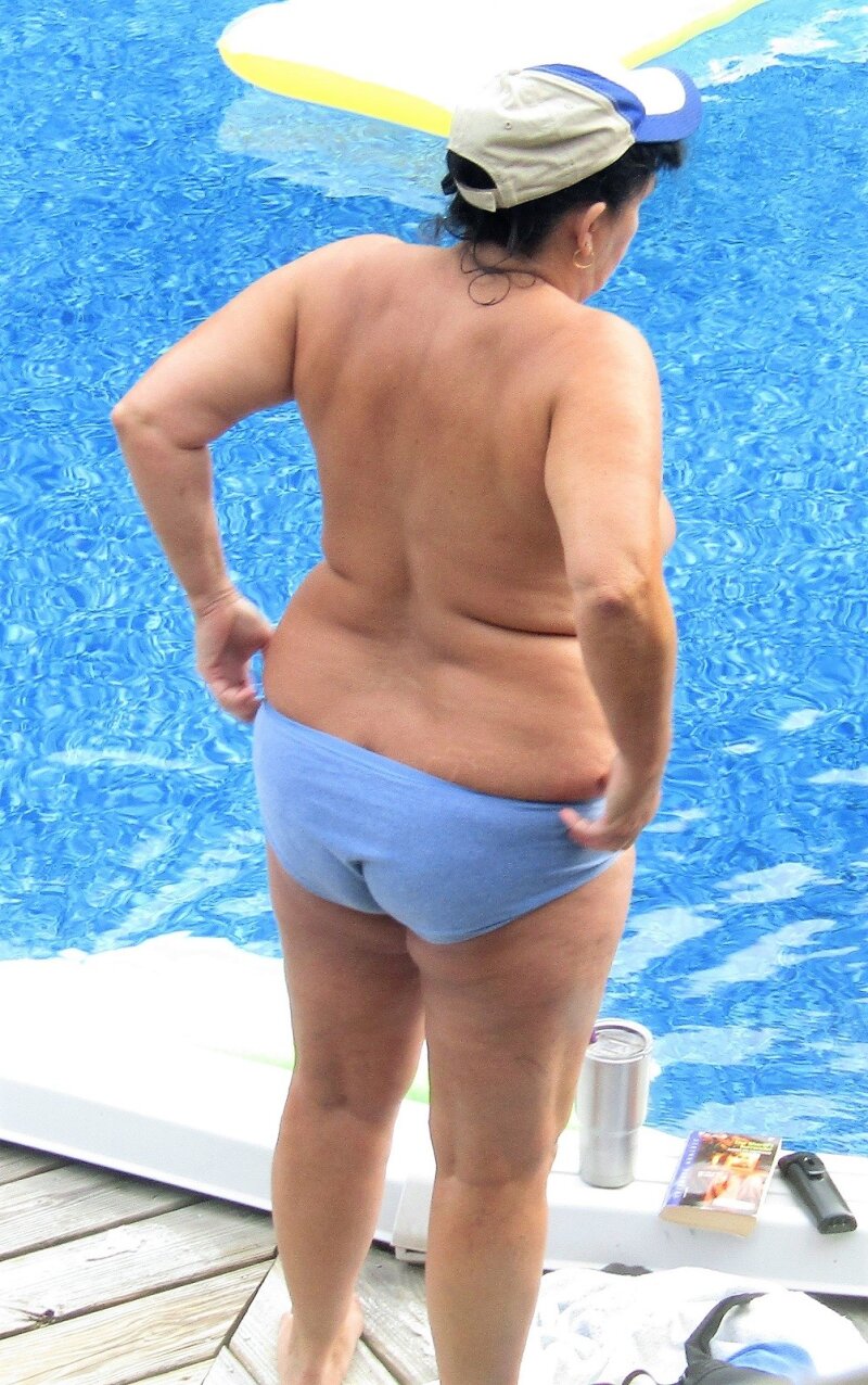The neighborhood whore undressing at the pool. picture