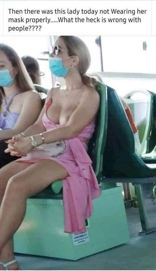 Woman with one boob out on bus wearing face mask. picture