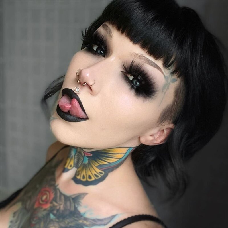 Goth woman with a split tongue picture