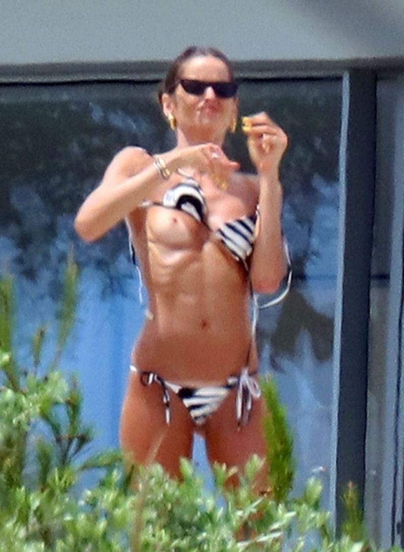 Izabel Goulart nude boobs caught by paparazzi in Saint Tropez as she is doing up her bikini accidentally exposing her topless tits also show picture