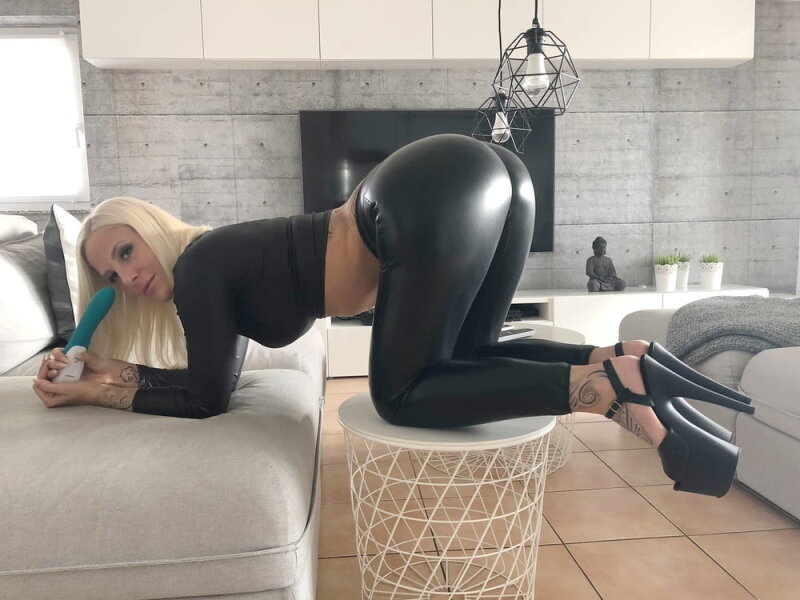 Lara Cumkitten with ass in wetlook leggings and platform heels picture