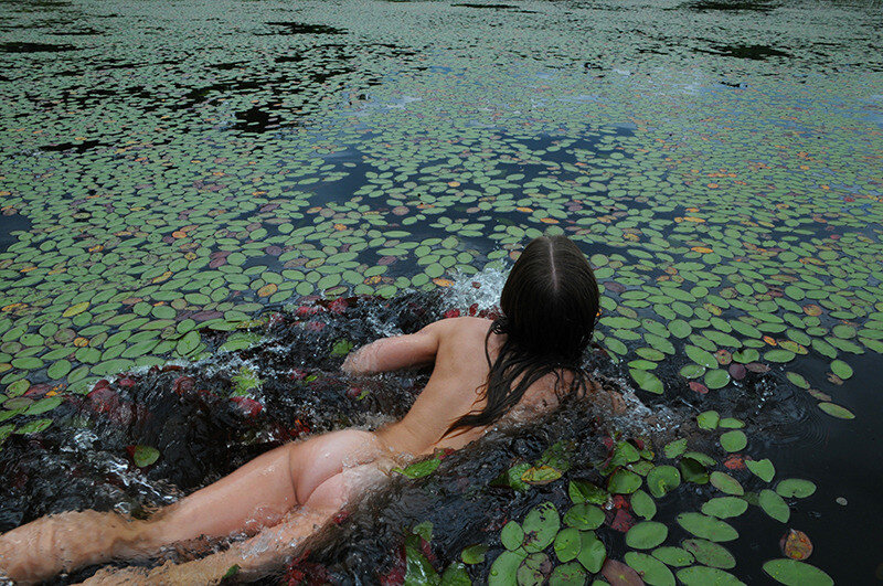 Beautiful Teen Swims in the Lake with the Lily Pads picture