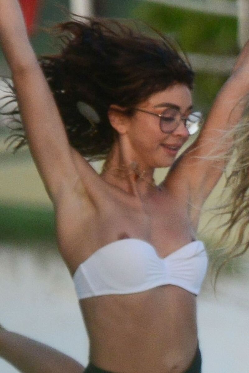 Sarah Hyland nip slip wardrobe malfunction accidentally flashing her nipples in a bikini at the beach in Mexico for New Years Eve seen by pa picture
