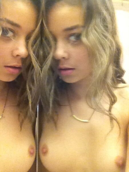 Sarah Hyland shows her boobs next to a mirror. picture