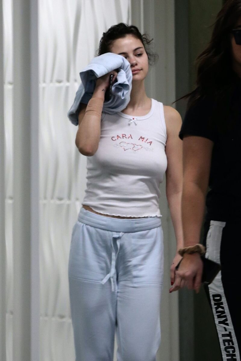 Selena Gomez braless boobs in a white tank top showing off her big tits pokies also wearing sweat pants seen by paparazzi visiting the docto picture