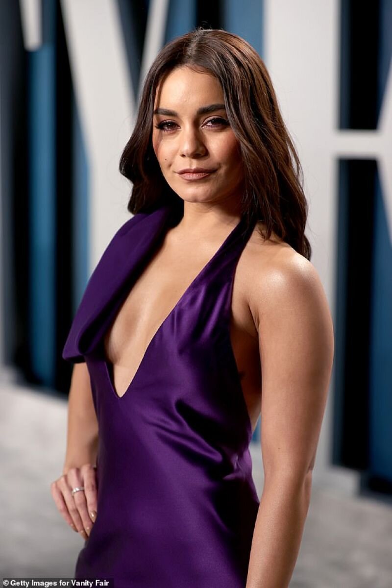 Vanessa Hudgens braless boobs showing nice cleavage with her big tits in a very low cut sexy purple dress arriving to Vanity Fair Oscar Part picture