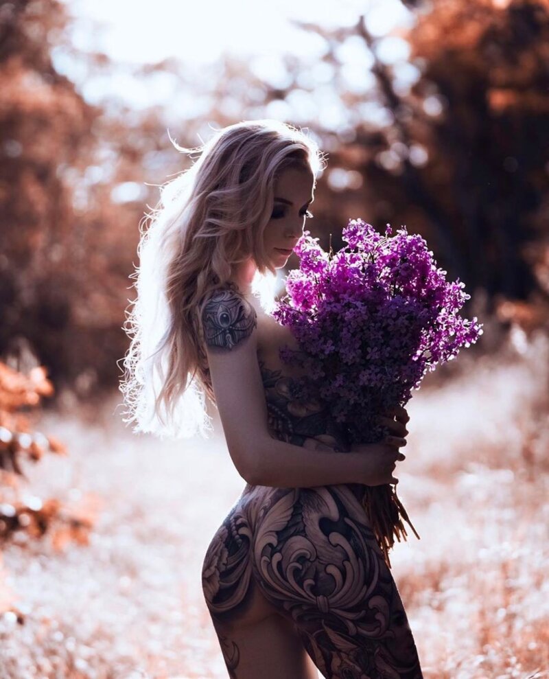 Tattooed blonde with flowers on a hot summer day picture