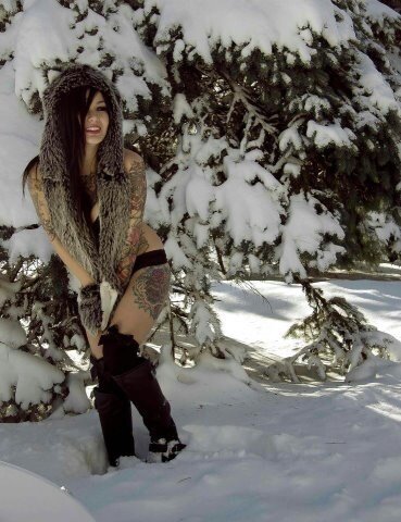 Tattooed hotty walking through the snow on a sunny winter day picture