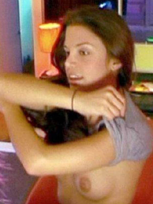 Vanessa Ferlito pulling off her shirt, showing a boob. picture