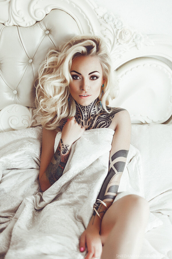 White bed with tattooed blonde. picture