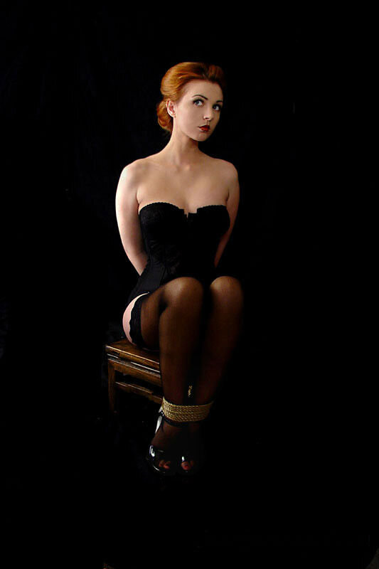#demure #bondage #redhead #corset #stockings #tied #armsback #ropebondage #bdsm #lipstick #glamour picture