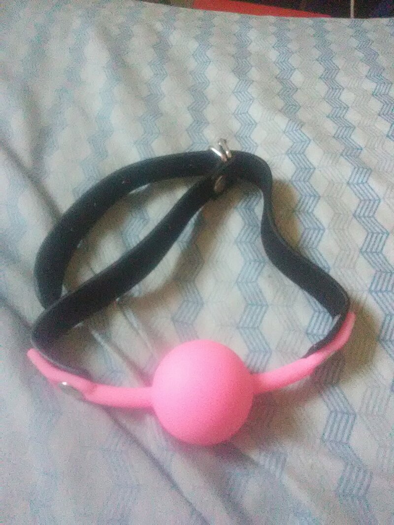A pink ballgag with a woman's name on it. picture